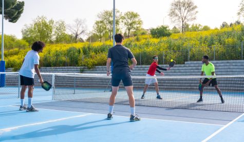 Friends playing pickleball in an outdoor court